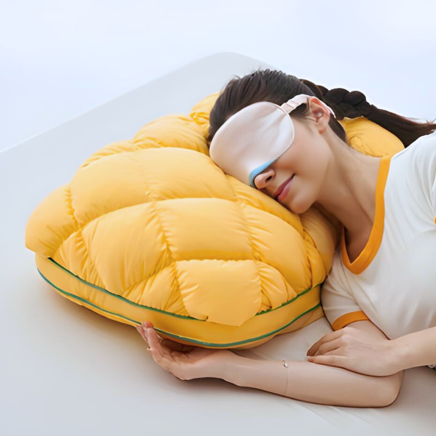 A single monstera leaf in a clear glass vase against a white background.